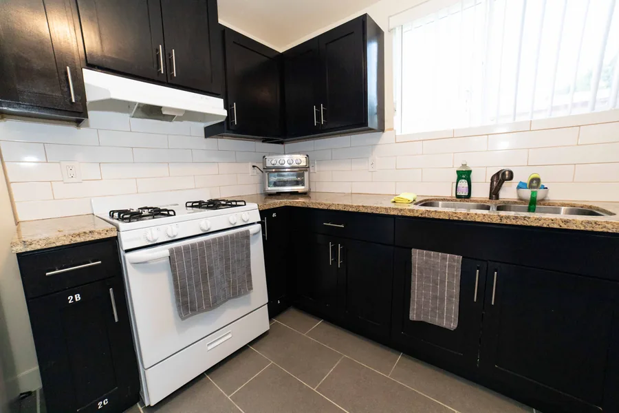 Kitchen with a gas range and dark cabinets