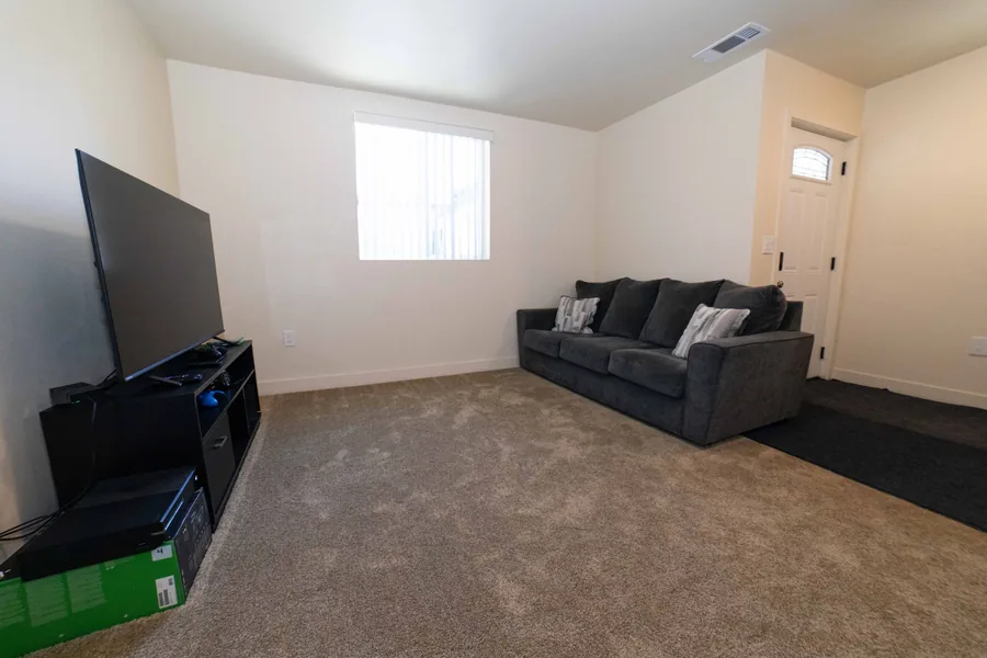 Upstairs living room with a sofa and a television