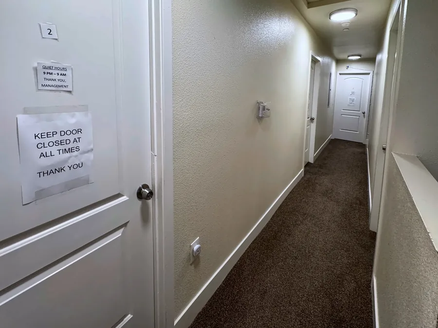 Carpeted hallway leading to the bedrooms at the East 69th Street house